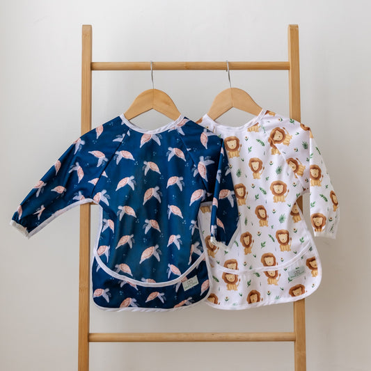 Bear & Moo Sleeved Bib in Tranquil Turtles & Leo the Lion print