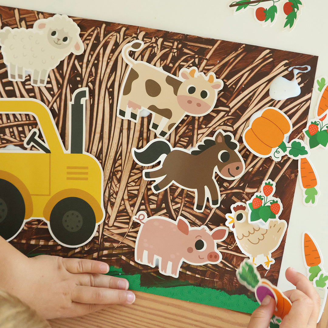 My Creative Box Farm Friends Craft and Activity Box, child placing farm decals on a scene